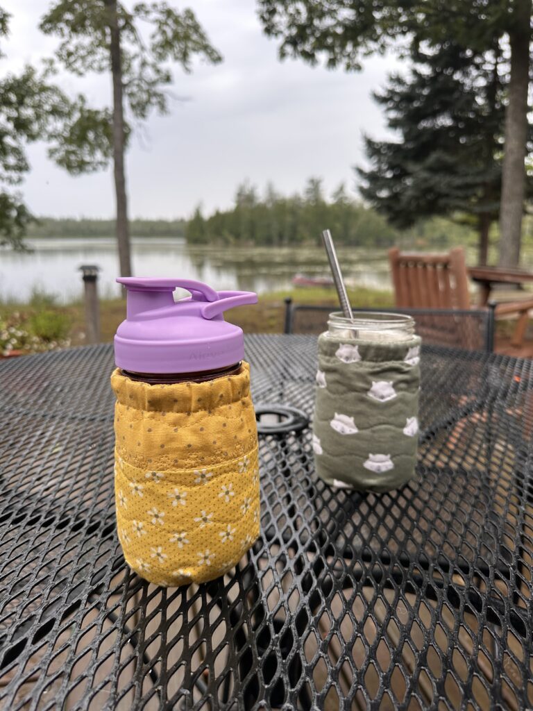 two flute mason jars with cozies